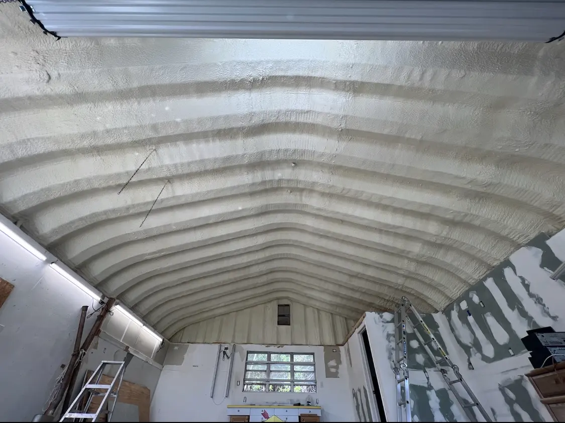 Spray polyurethane foam applied to the underside of a metal roof deck in Monroe